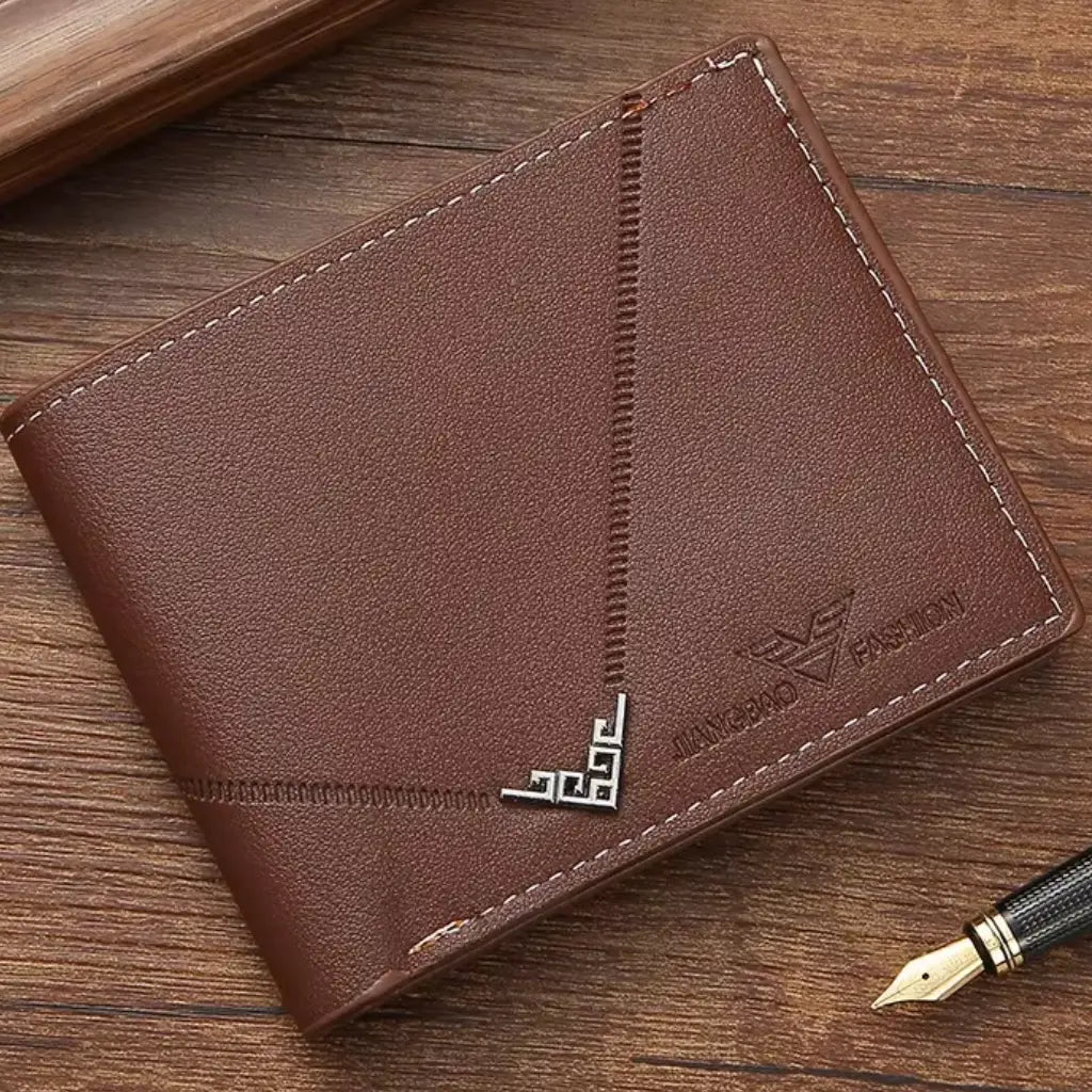 Angled view of the closed brown Arlen slim wallet on a wooden surface.