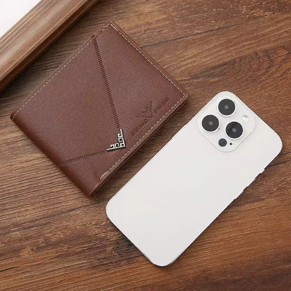 Brown slim men’s wallet beside a smartphone on a wooden surface.