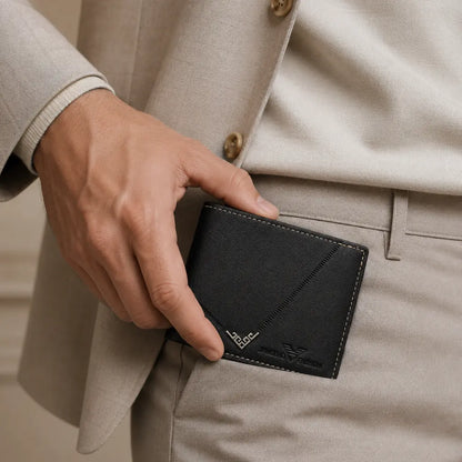 Man placing the Wallet for Men Slim Model Arlen Black by CORVIKO into a tailored trouser pocket