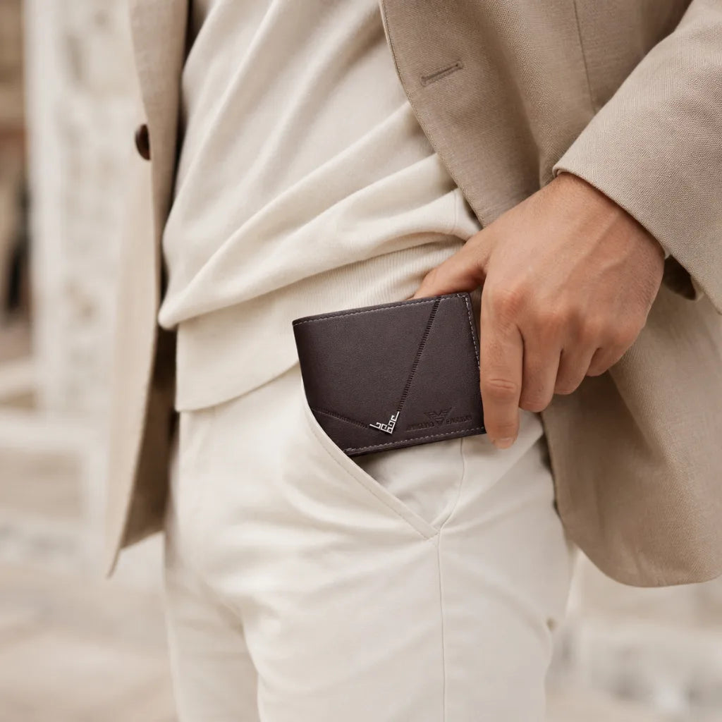 Man placing the Wallet for Men Slim Model Arlen Coffee by CORVIKO into a trouser pocket in a refined everyday outfit