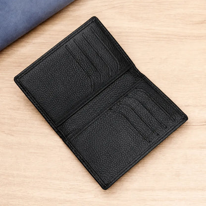 Black leather card holder for men opened to show multiple card slots and interior organization