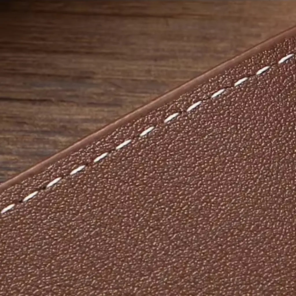 Close-up of the wallet’s textured brown surface and diagonal stitched design.